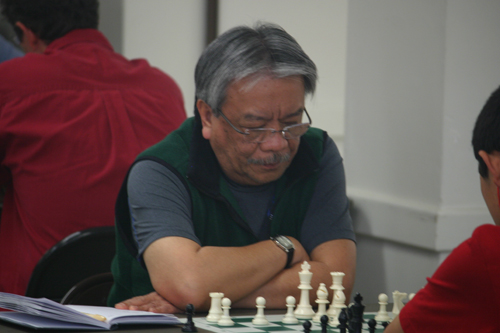 Raoul Crisologo pondering his move against Ryan Chen.